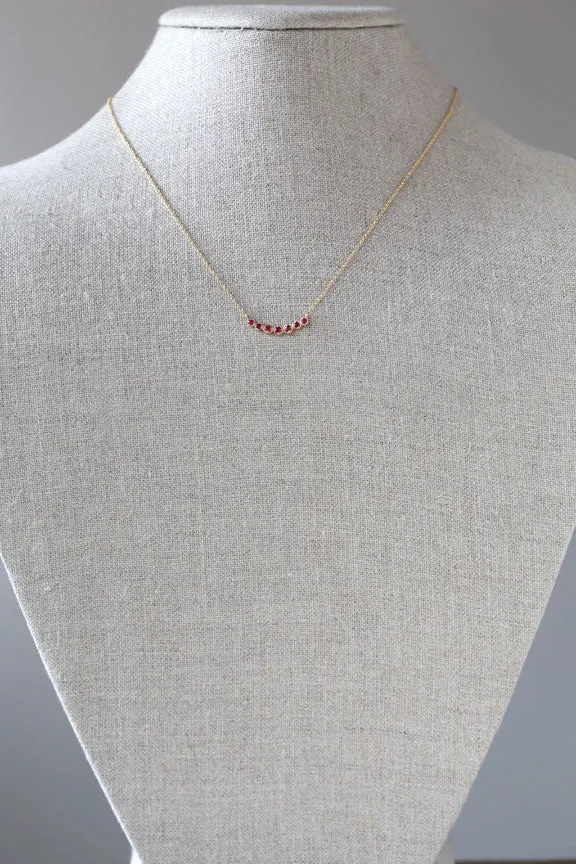 Curved 7 bezel ruby necklace