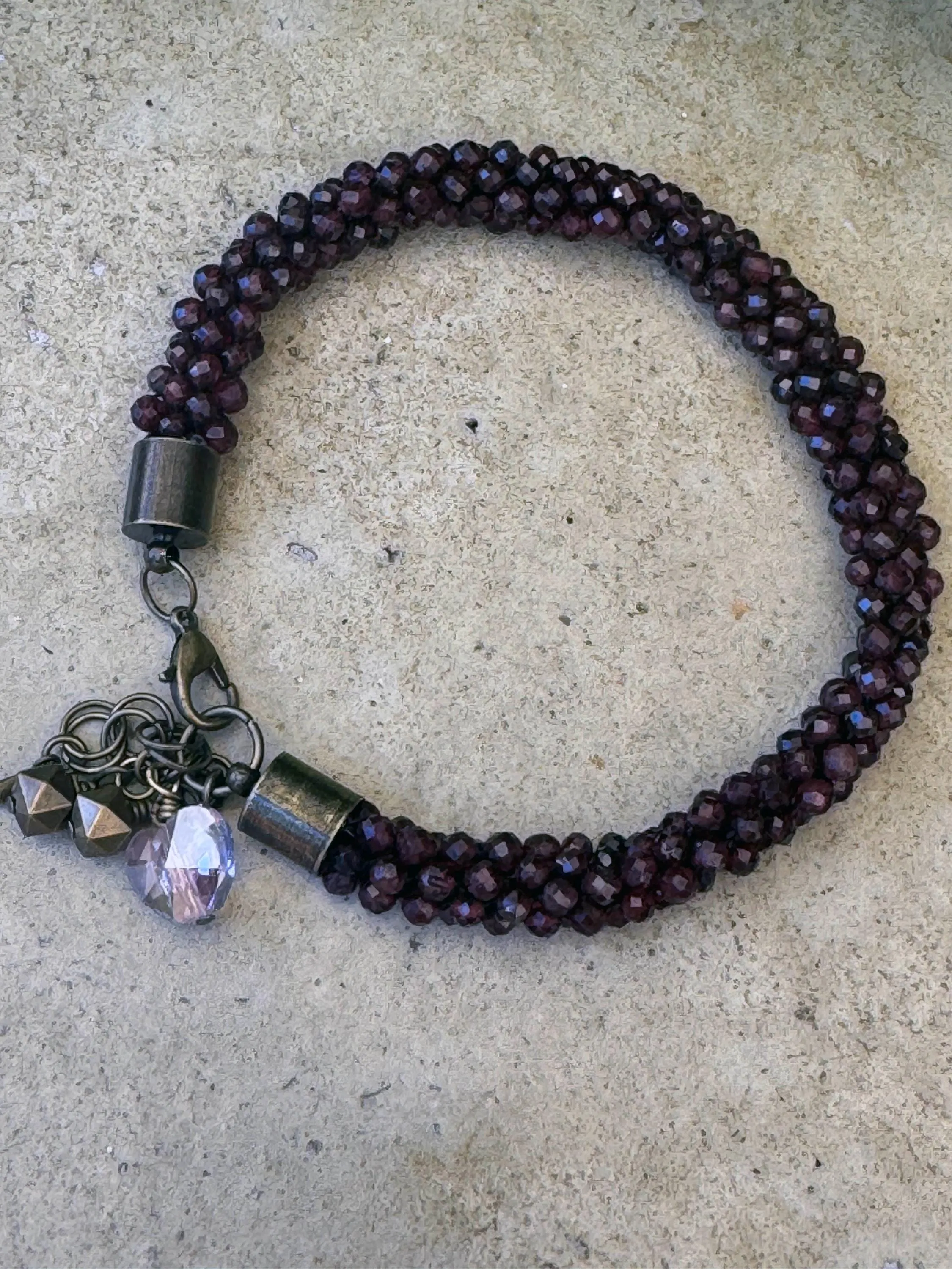Kumihimo Garnet Gemstone Bracelet - Garnet Gemstone bracelet with flower hanging charm.